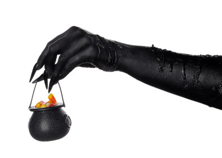 Black hand of witch with cauldron on white background. Halloween celebrationの写真素材