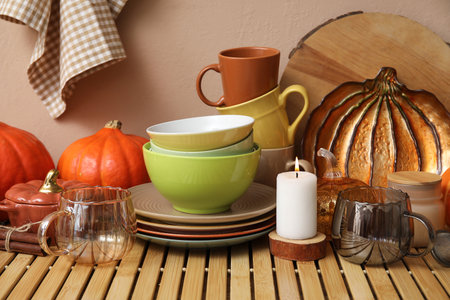 Different dishes, pumpkins and autumn decor on wooden table in kitchenの写真素材
