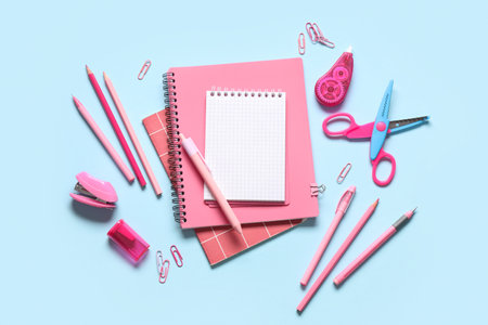Blank notebook with different stationery supplies on blue backgroundの写真素材