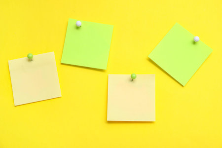 Paper notes pinned on yellow background