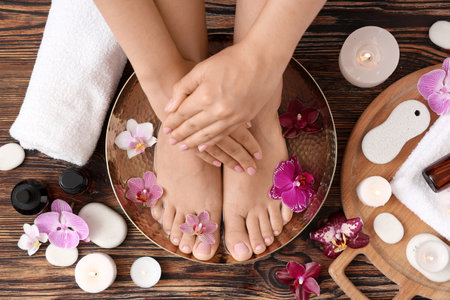 Woman undergoing spa pedicure treatment on wooden backgroundの写真素材