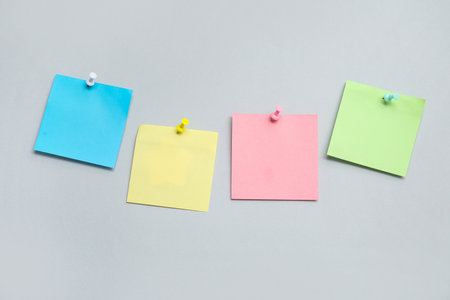 Paper notes pinned on gray backgroundの写真素材