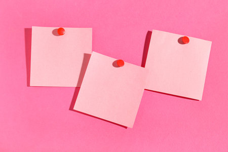 Paper notes pinned on pink background