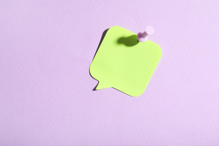 Paper note in shape of speech bubble pinned on lilac backgroundの写真素材