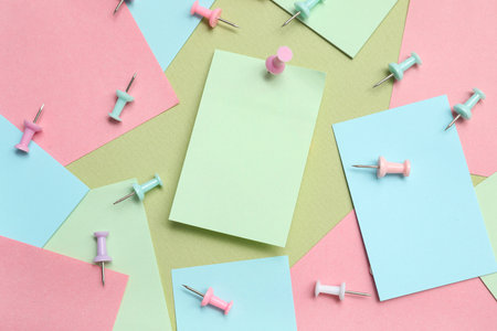 Paper notes with pins on green backgroundの写真素材