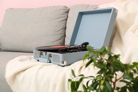 Record player with disk on sofa in roomの写真素材