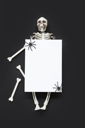 Blank card and Halloween decorations on dark background, top viewの写真素材