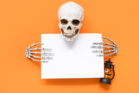 Blank card and Halloween decorations on orange background, top viewの写真素材