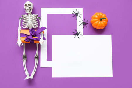 Blank card and Halloween decorations on purple background, top viewの写真素材