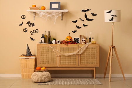 Interior of living room decorated for Halloween with commode and pumpkinsの写真素材