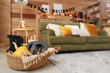Basket with Halloween pumpkins and decor in living room, closeupの写真素材