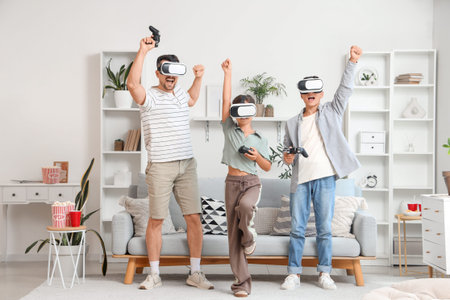 Happy father with his children in VR glasses playing video game at home