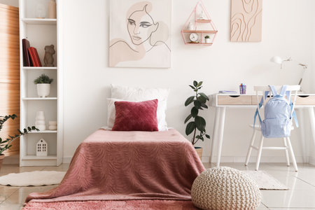 Interior of teenager's room with bed, shelf unit and workplaceの写真素材