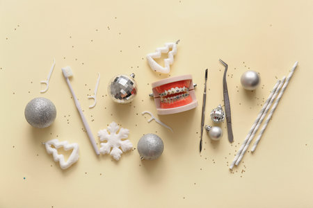 Composition with jaw model, dentist's tools and Christmas decorations on color backgroundの写真素材