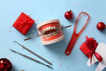 Composition with dentist's tools, Christmas gifts and decorations on color backgroundの写真素材