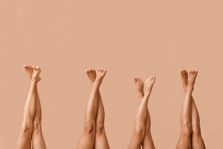 Legs of beautiful different body positive women on beige background, closeupの写真素材