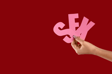 Woman with the word SEX on red backgroundの写真素材