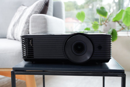 Video projector on table in living room, closeup