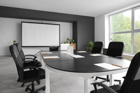 Interior of conference hall with table and projector screen
