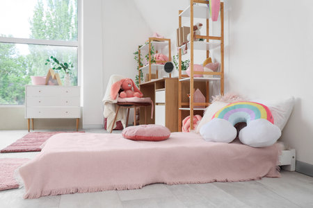 Interior of children's room with bed, study table and shelf unitsの写真素材