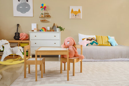 Interior of children's room with bed, table and toysの写真素材