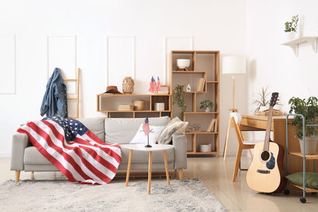 Interior of light living room with gray sofa, wooden furniture and USA flagsの写真素材