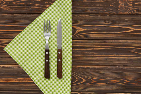 Checkered napkin and cutlery on wooden backgroundの写真素材