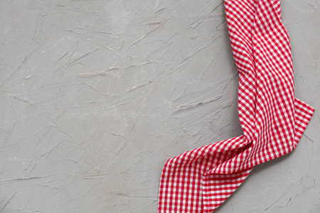 Red checkered napkin on gray grunge backgroundの写真素材