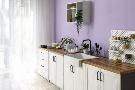Interior of modern kitchen with white counters