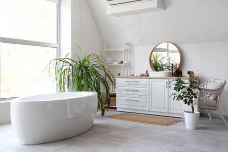 Interior of bathroom with mirror, sink and bathtubの写真素材
