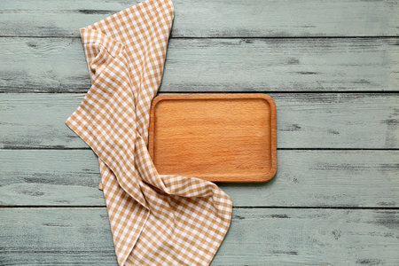 Table setting with board and napkin on gray wooden backgroundの写真素材