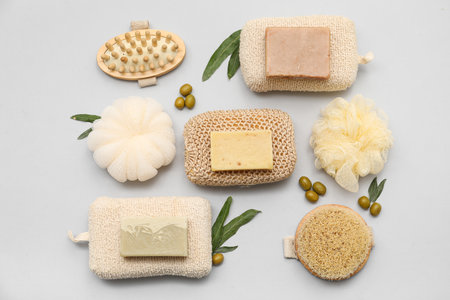 Composition with natural soap bars, bath supplies and green olives on gray backgroundの写真素材