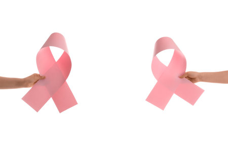 Women holding paper pink ribbons on white background. Breast cancer awareness conceptの写真素材