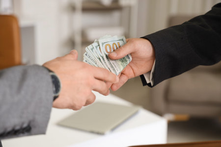 Young business men with bribe in office, closeup. Corruption concept