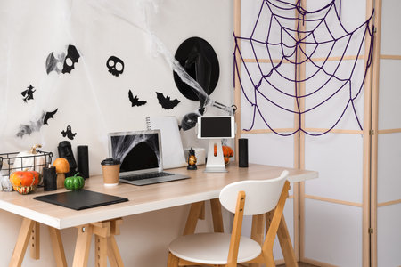 Interior of office decorated for Halloween with workplace and folding screenの写真素材