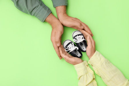 Couple with baby boots on green background, top viewの写真素材