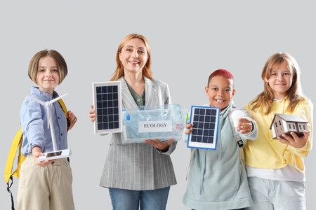 Pupils and teacher with environmental things on light background. Ecology conceptの写真素材