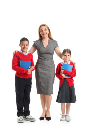 Mature teacher hugging little pupils on white backgroundの写真素材