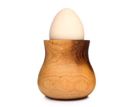 Wooden holder with tasty boiled quail egg on white background