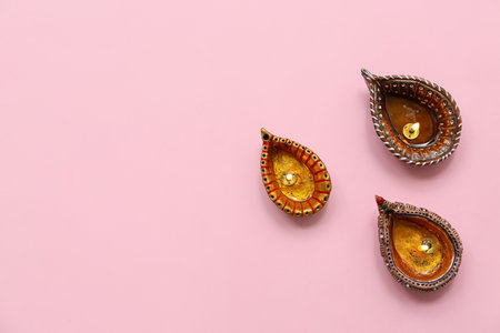 Diya lamps on pink background. Divaly celebrationの写真素材