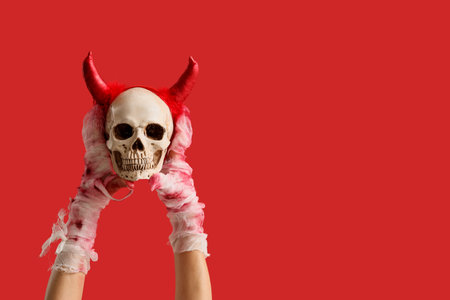 Mummy hands with skull on red background. Halloween celebrationの写真素材