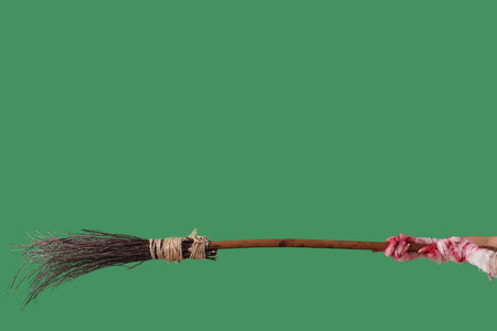 Mummy hands with broom on green background. Halloween celebrationの写真素材