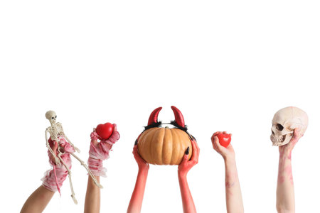 Mummy, zombie and devil hands with Halloween decorations on white backgroundの写真素材