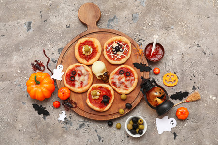 Composition with different mini pizzas, ingredients and different decorations for Halloween on grunge backgroundの写真素材