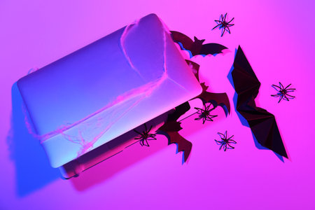 Composition with modern laptop and different decorations for Halloween on color backgroundの写真素材