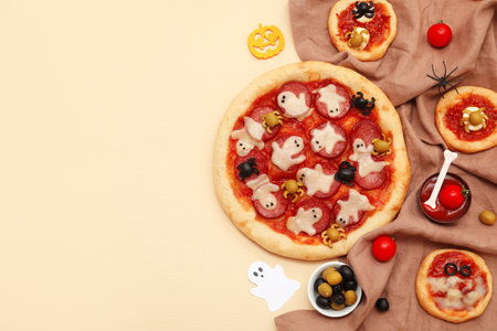 Composition with tasty Halloween pizzas, olives and tomato sauce on color backgroundの写真素材