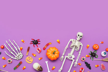 Composition with sweets and decorations for Halloween on purple backgroundの写真素材