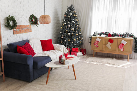 Interior of living room with Christmas tree, gray sofa and festive decorationsの写真素材
