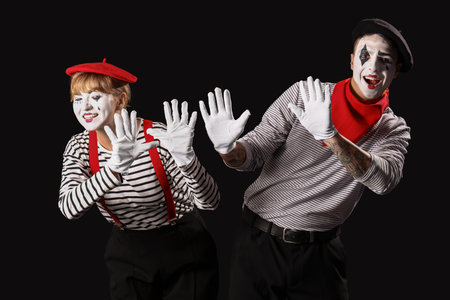 Couple of pantomimists on black backgroundの写真素材