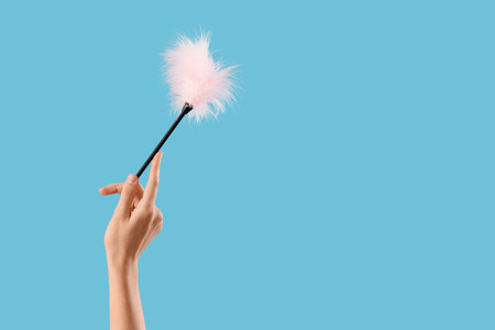 Woman with feather stick from sex shop on blue background